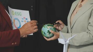Business people holding a globe and a paper with a map on it video