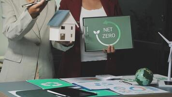 Two business people holding up a net zero sign video