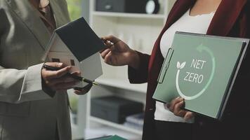 Two people holding folders with the word get zero on them video
