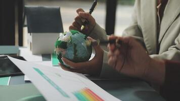Business people working on a project with a globe video