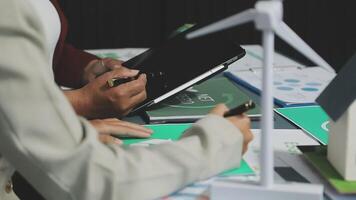 A man is writing on a tablet while sitting at a desk video
