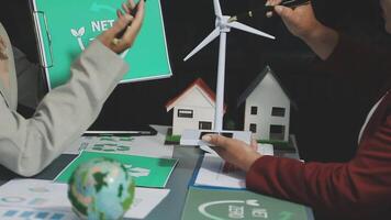 Two people working on a project with a wind turbine video