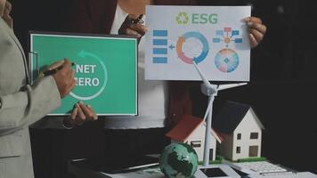 Two people holding up a sign that says net zero video
