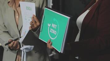 Two business people holding a folder with the word nt edo on it video