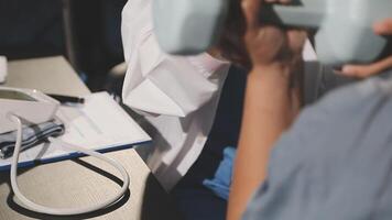 A doctor is holding a dumbbell while another person is sitting at a desk video