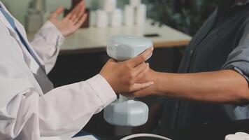A doctor is holding a dumbbell while another person is holding a bottle video