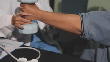 A doctor is holding a dumbbell while another person is holding a phone video