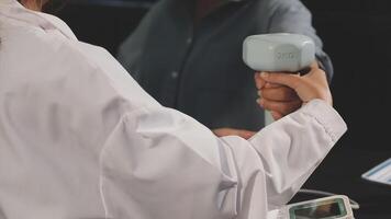 A person holding a handheld device with a white case video