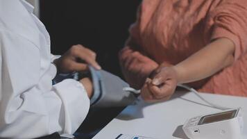 A person is checking their blood pressure with a digital device video