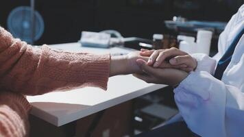 A doctor is holding the hand of a patient video