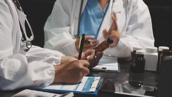 Two doctors are talking on a table video