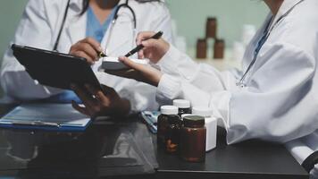 Two doctors are working on a tablet video