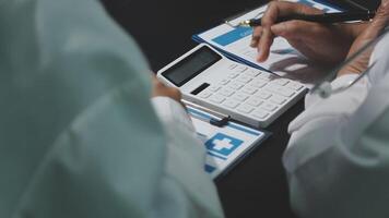 A doctor is using a calculator to calculate the cost of a procedure video