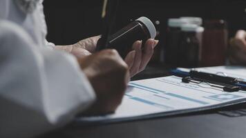 A doctor is using a cell phone while sitting at a desk video