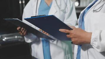 Two doctors holding a clipboard and looking at something video