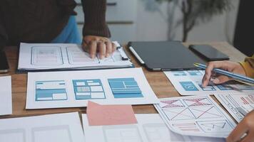 A person is working on a design document on a desk video