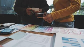 Two people standing around a table with a design on it video
