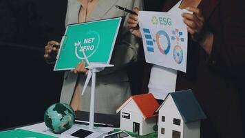 Two people holding up a sign that says net zero video
