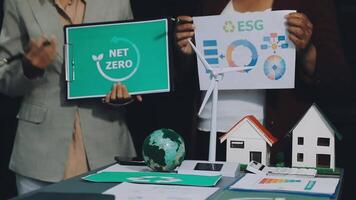 Two people holding up signs that say net zero video