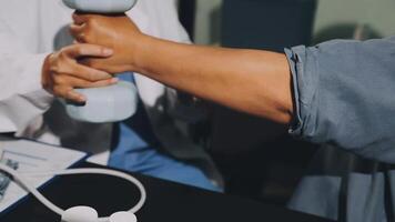 A doctor is holding a dumbbell while another person is holding a phone video