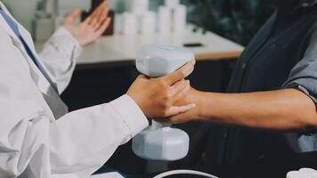 A doctor is holding a dumbbell while another person is holding it video