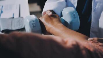 A doctor is holding a dumbbell in front of a person video