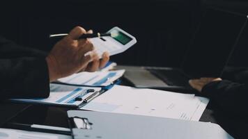 Business people working on paperwork at a desk video
