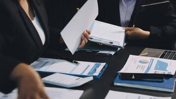 Business people working on paperwork at a desk video