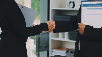 Two business people shaking hands over a clipboard video