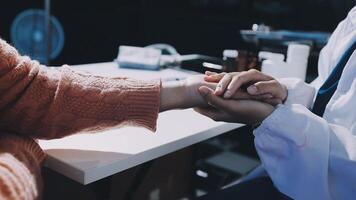 A doctor is holding the hand of a patient video