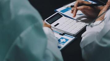 Two doctors are working on a calculator video