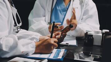 Two doctors are talking on a table video