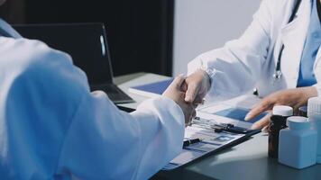 Two doctors shaking hands at a desk video