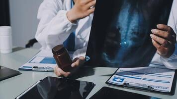 Two doctors looking at an x - ray image on a tablet video