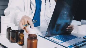 A doctor is looking at a x - ray image on a table video