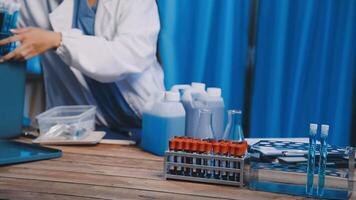 A woman in lab coat is working on a computer video