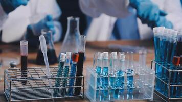 A group of people in lab coats are working on a project video