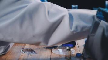 A person in a lab coat is working on something video