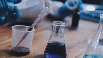 A person in blue gloves is holding a test tube video