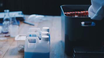 A person in a lab coat is holding a container video
