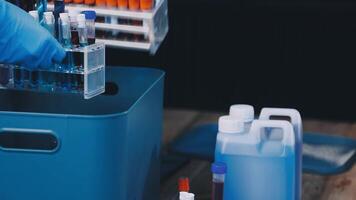 A person in a blue glove holding a container with a blue liquid video