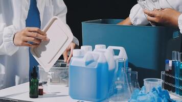 Two people in lab coats are working on a table video