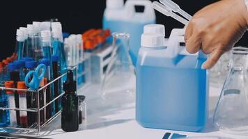 A person is holding a bottle of liquid in a laboratory video