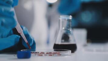 A person in blue gloves is holding a test tube video