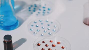 A table with several blue and red liquid drops video