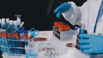 A person in a lab coat is working on a table video