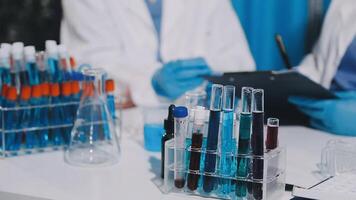 Two people in lab coats are working on a project video