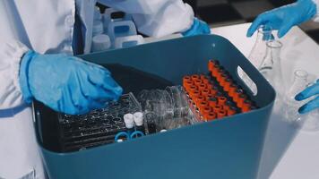 A person in a lab coat is holding a container video