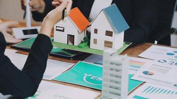 A group of people are looking at a house model video