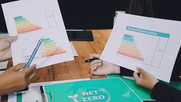 Two people holding papers with graphs on them video